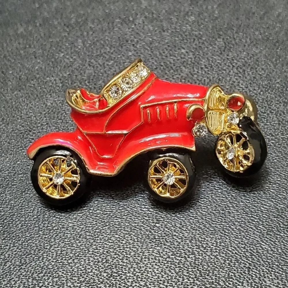 Gold tone red enamel antique car brooch